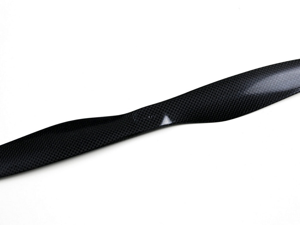 View of the black carbon fiber drone propeller (two-blade) showing the pitch angle